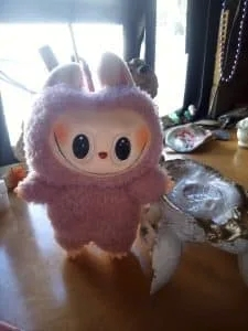 Pink fluffy Lafufu doll with wide smile